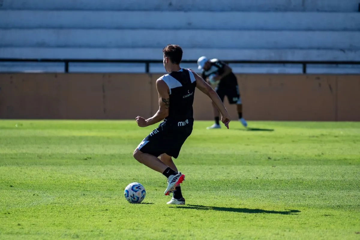 Footballer training on the pitch, in an article about footballers who had a hair transplant