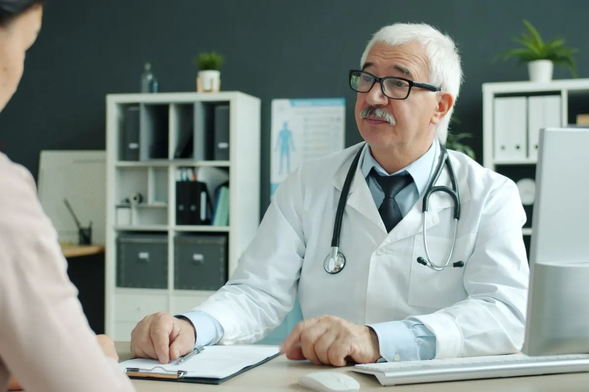 Doctor at his desk during a consultation about hair transplant cost in Turkey